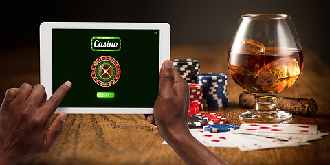 Image showing Online gambling, casino concept. Hand holding device with lottery, casino cover