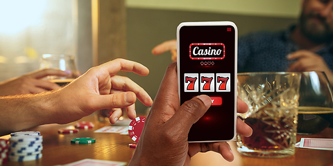 Image showing Online gambling, casino concept. Hand holding device with lottery, casino cover