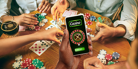 Image showing Online gambling, casino concept. Hand holding device with lottery, casino cover