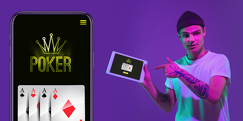 Image showing Online gambling, casino concept. Young man holding devices with lottery, casino cover in neon light