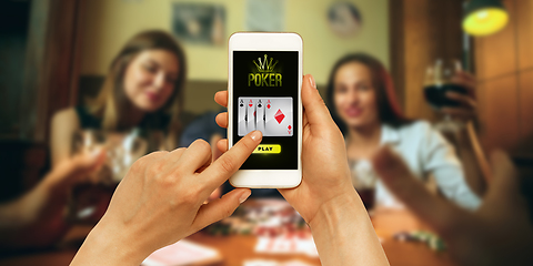 Image showing Online gambling, casino concept. Hand holding device with lottery, casino cover