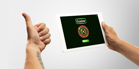 Image showing Online gambling, casino concept. Hand holding device with lottery, casino cover