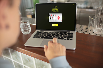 Image showing Online gambling, casino concept. Hand near laptop, device with lottery, casino cover