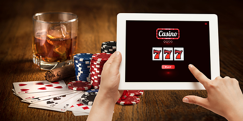 Image showing Online gambling, casino concept. Hand holding device with lottery, casino cover