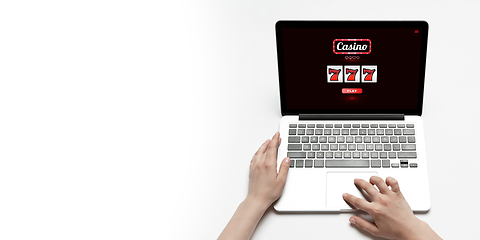 Image showing Online gambling, casino concept. Hand near laptop, device with lottery, casino cover