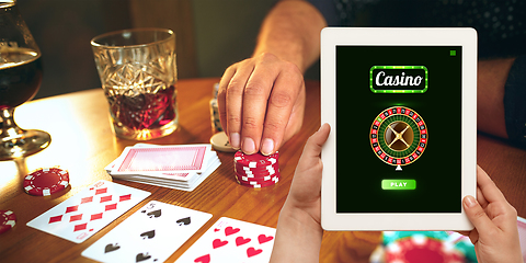 Image showing Online gambling, casino concept. Hand holding device with lottery, casino cover