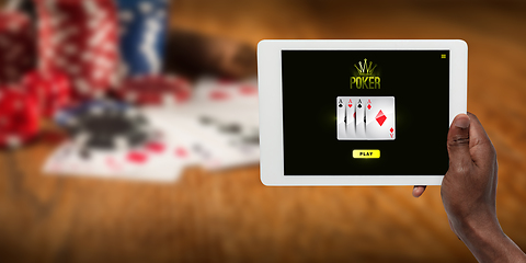 Image showing Online gambling, casino concept. Hand holding device with lottery, casino cover