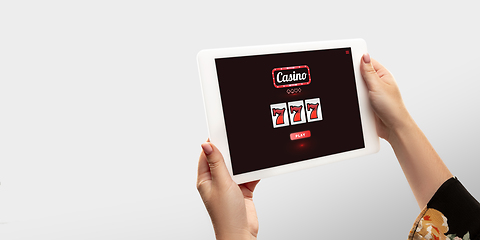 Image showing Online gambling, casino concept. Hand holding device with lottery, casino cover