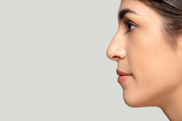 Image showing Close up portrait of beautiful jewish woman isolated on studio background. Beauty, fashion, skincare, cosmetics concept. Details.