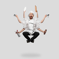Image showing Cooker, chef, baker in uniform multitask like shiva isolated on gray studio background