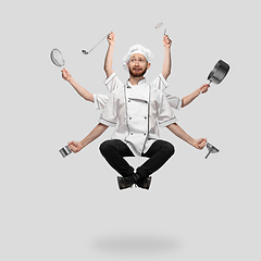 Image showing Cooker, chef, baker in uniform multitask like shiva isolated on gray studio background