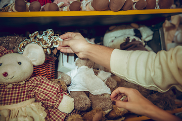 Image showing Close up hands of woman looking for home decoration and holiday\'s gifts in household store