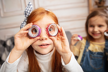 Image showing Two little children, girls together in creativity of the house. Happy kids make handmade toys for games or New Year celebration