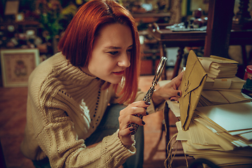 Image showing Smiling woman looking for home decoration and holiday\'s gifts in household store