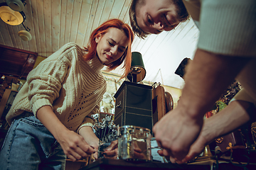 Image showing Smiling family, couple looking for home decoration and holiday\'s gifts in household store