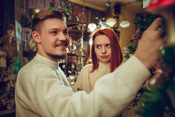 Image showing Smiling family, couple looking for home decoration and holiday\'s gifts in household store