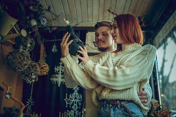 Image showing Smiling family, couple looking for home decoration and holiday\'s gifts in household store