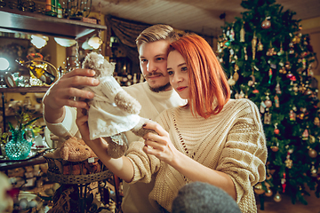 Image showing Smiling family, couple looking for home decoration and holiday\'s gifts in household store