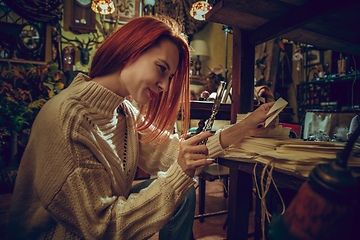 Image showing Smiling woman looking for home decoration and holiday\'s gifts in household store