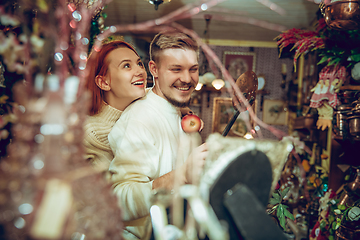 Image showing Smiling family, couple looking for home decoration and holiday\'s gifts in household store