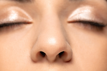 Image showing Close up portrait of beautiful jewish woman isolated on studio background. Beauty, fashion, skincare, cosmetics concept. Details.