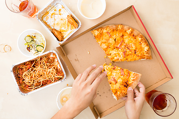 Image showing Top view of eating pizza at home