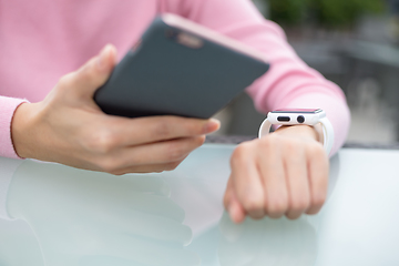 Image showing Woman connecting cellphone and smart watch