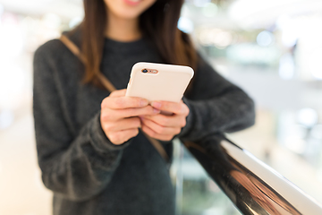 Image showing Woman sending sms on cellphone