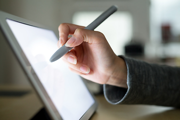 Image showing Woman drawing on tablet with pen