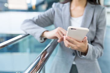 Image showing Businesswoman sending sms on mobile phone