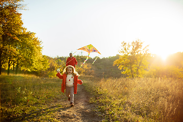 Image showing Happy father and little cute daughter walking down the forest path in autumn sunny day