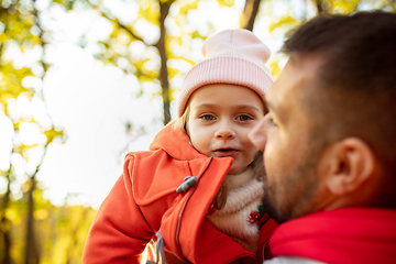 Image showing Happy father and little cute daughter walking down the forest path in autumn sunny day