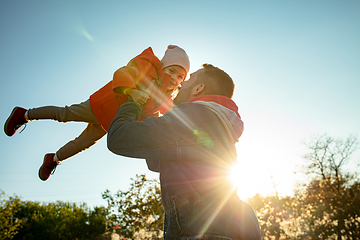 Image showing Happy father and little cute daughter walking down the forest path in autumn sunny day