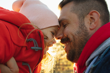 Image showing Happy father and little cute daughter walking down the forest path in autumn sunny day