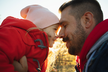 Image showing Happy father and little cute daughter walking down the forest path in autumn sunny day