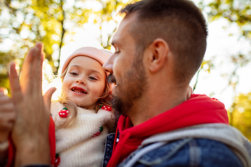 Image showing Happy father and little cute daughter walking down the forest path in autumn sunny day