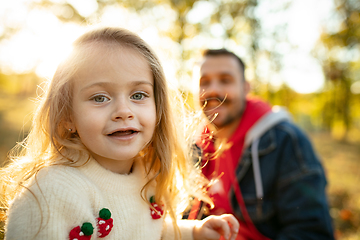 Image showing Happy father and little cute daughter walking down the forest path in autumn sunny day