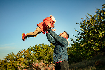 Image showing Happy father and little cute daughter walking down the forest path in autumn sunny day