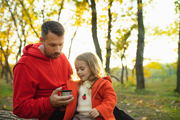 Image showing Happy father and little cute daughter walking down the forest path in autumn sunny day