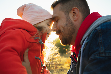 Image showing Happy father and little cute daughter walking down the forest path in autumn sunny day