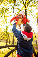 Image showing Happy father and little cute daughter walking down the forest path in autumn sunny day