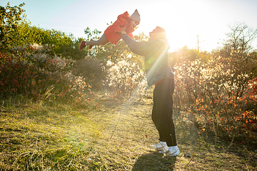 Image showing Happy father and little cute daughter walking down the forest path in autumn sunny day