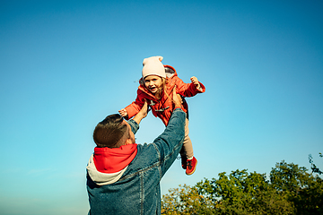 Image showing Happy father and little cute daughter walking down the forest path in autumn sunny day