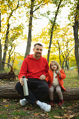 Image showing Happy father and little cute daughter walking down the forest path in autumn sunny day