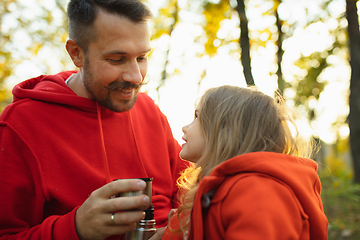 Image showing Happy father and little cute daughter walking down the forest path in autumn sunny day