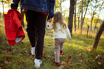 Image showing Happy father and little cute daughter walking down the forest path in autumn sunny day