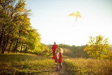 Image showing Happy father and little cute daughter walking down the forest path in autumn sunny day