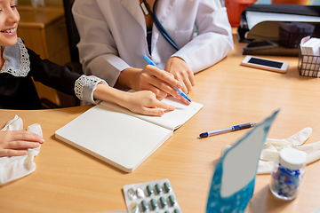 Image showing Paediatrician doctor examining a child in comfortabe medical office