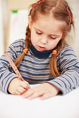 Image showing Cute little girl painting at home