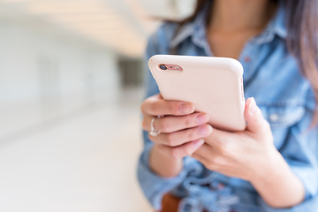 Image showing Woma using cellphone